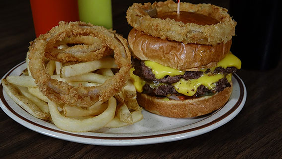 delicious double burger with onion ring on top